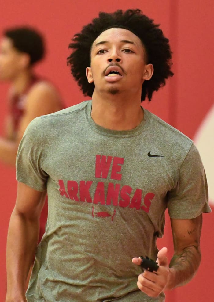 Razorbacks freshman Nick Smith runs on the side at Wednesday's practice. The guard was limited in practice with his finger in a splint after suffering a bone bruise Monday.